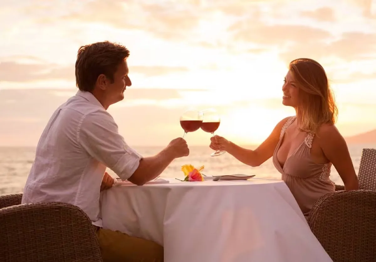 Couple toasting at sunset dinner